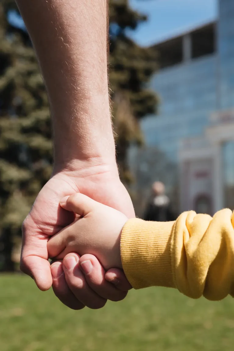 cropped picture father holding hand his little son